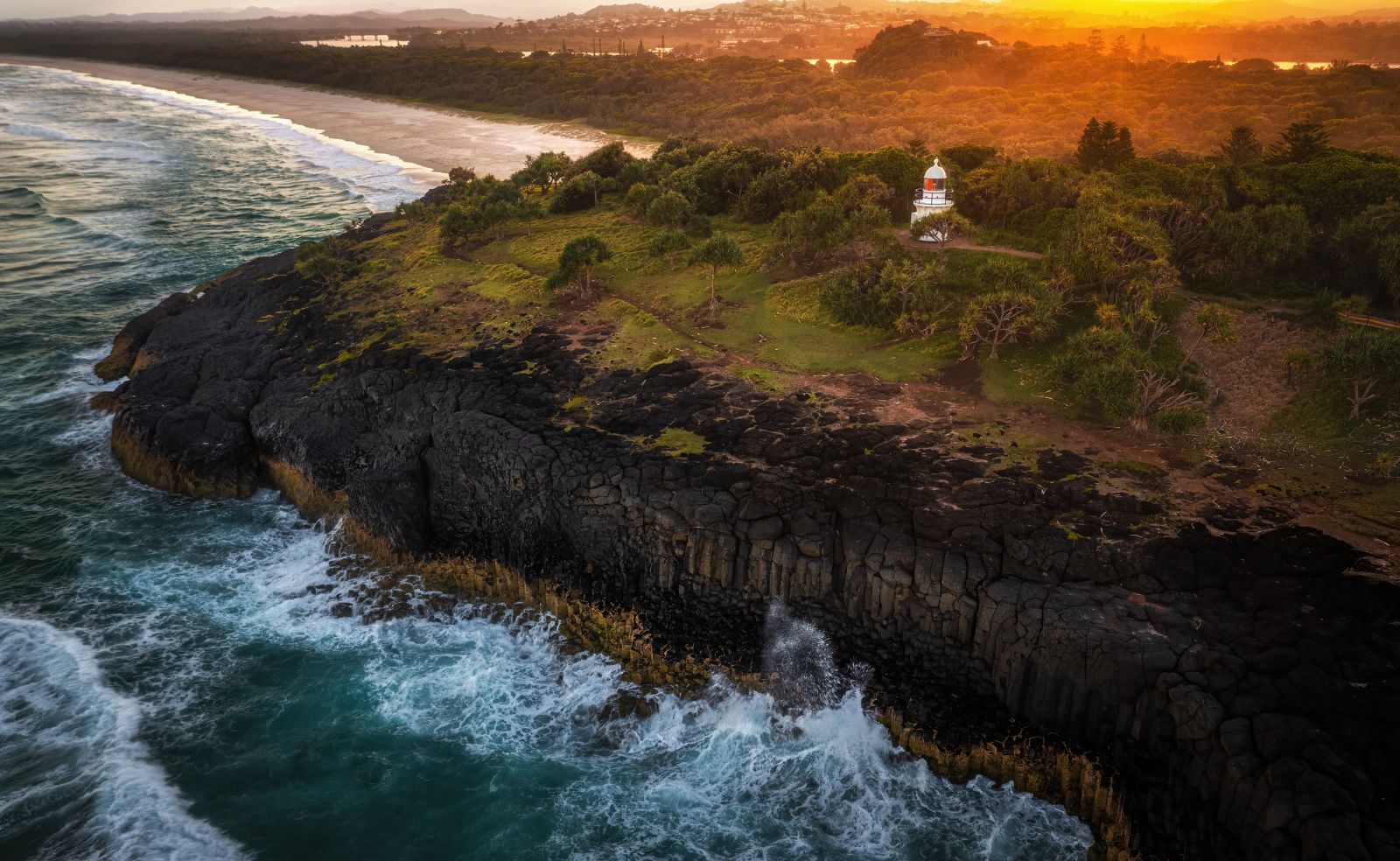 Arial shot of the lighthouse at Fingal Headland during sunset