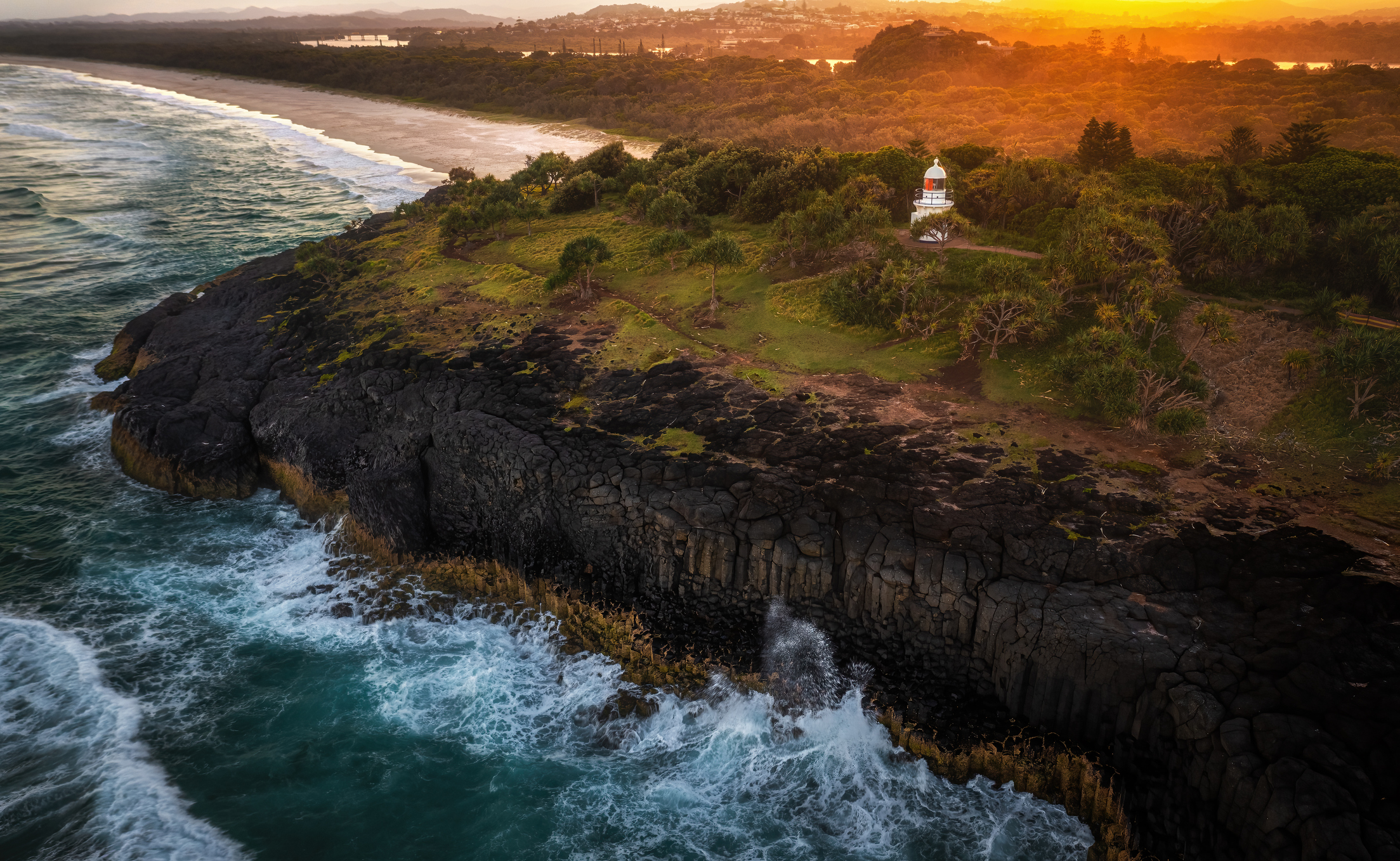Arial shot of the lighthouse at Fingal Headland during sunset